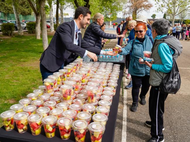 El alcalde, Alejandro Navarro, la concejala de Sanidad, Carla Picazo, repartiendo fruta a los participantes en la actividad de gimnasia y desayuno saludable